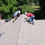 Roofers replacing a roof with precision and care